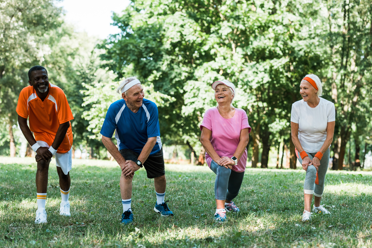 cheerful senior and multicultural people doing stretching exerci